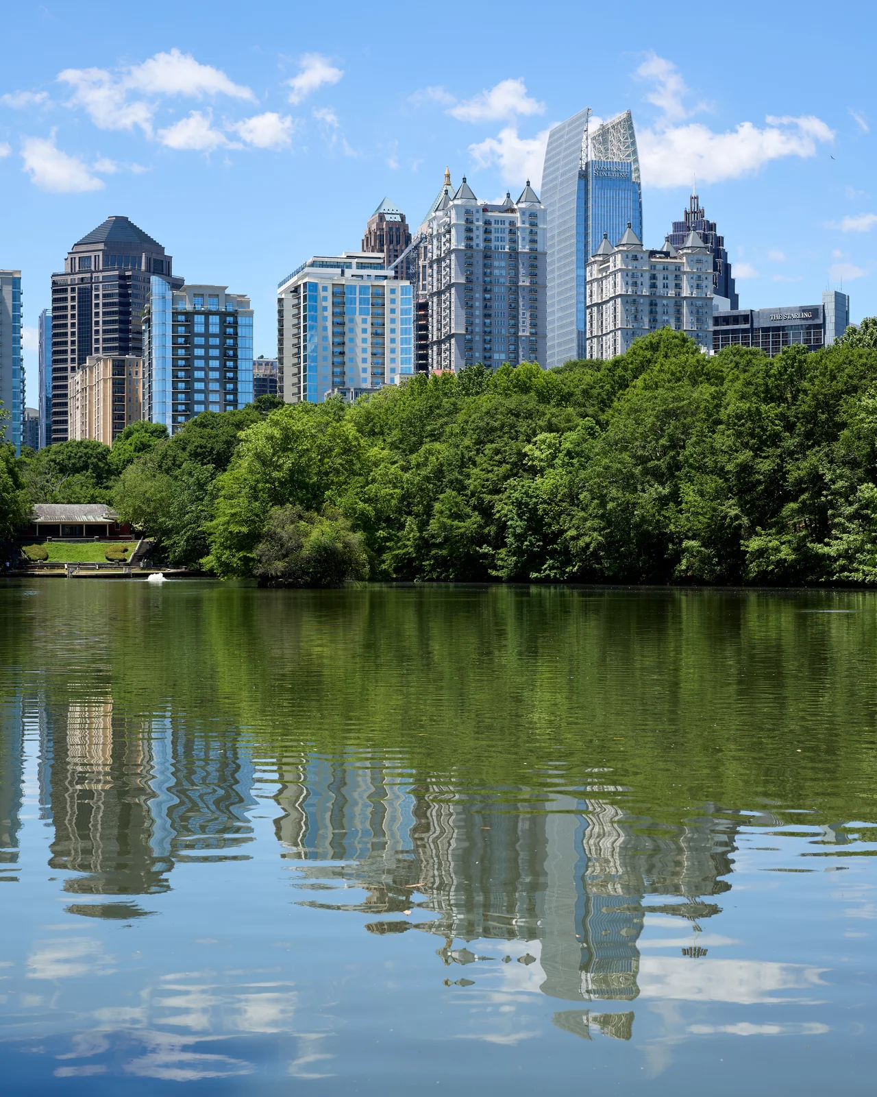 Midtown Atlanta’s towers reflect in Lake Clara Meer in Piedmont Park.